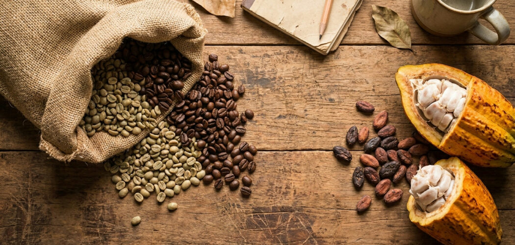 Coffee and cocoa futures: coffee beans spilling from a sack beside an open cocoa pod