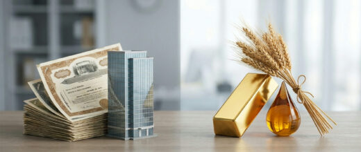 Commodities vs stocks: stock certificates and office model beside gold, oil and wheat
