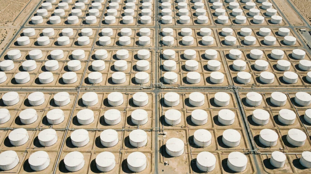 EIA Weekly Petroleum Status Report: aerial view of an oil tank farm with rows of storage tanks