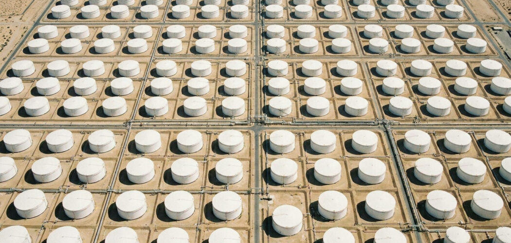 EIA Weekly Petroleum Status Report: aerial view of an oil tank farm with rows of storage tanks